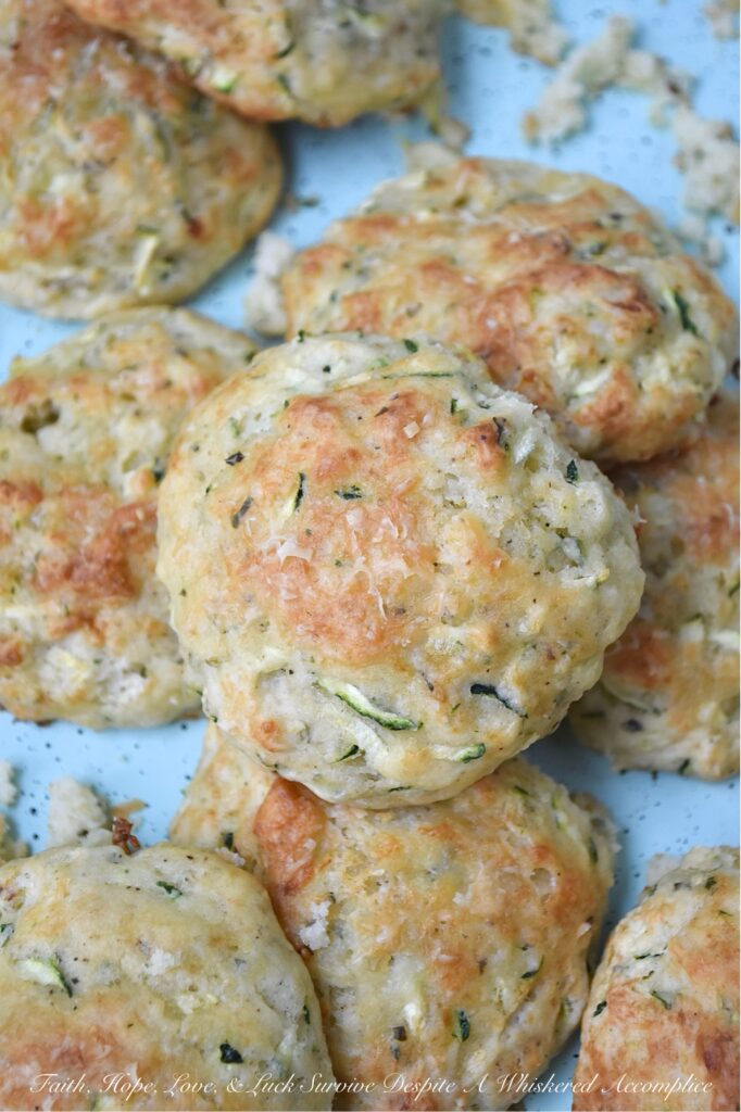 Parmesan Cheese Italian Zucchini Drop Biscuits - Packed with savory Italian seasoning and the irresistible tang of Parmesan cheese, these buttery zucchini biscuits offer a crispy, flaky texture that pairs beautifully with just about anything. You can serve them as a side to your favorite soups or salads, but honestly, they’re just as good for breakfast with a big ol’ pat of butter melting on top. If you’re looking for an easy-to-make biscuit recipe that’s got a little something extra going on, these zucchini drop biscuits are it.