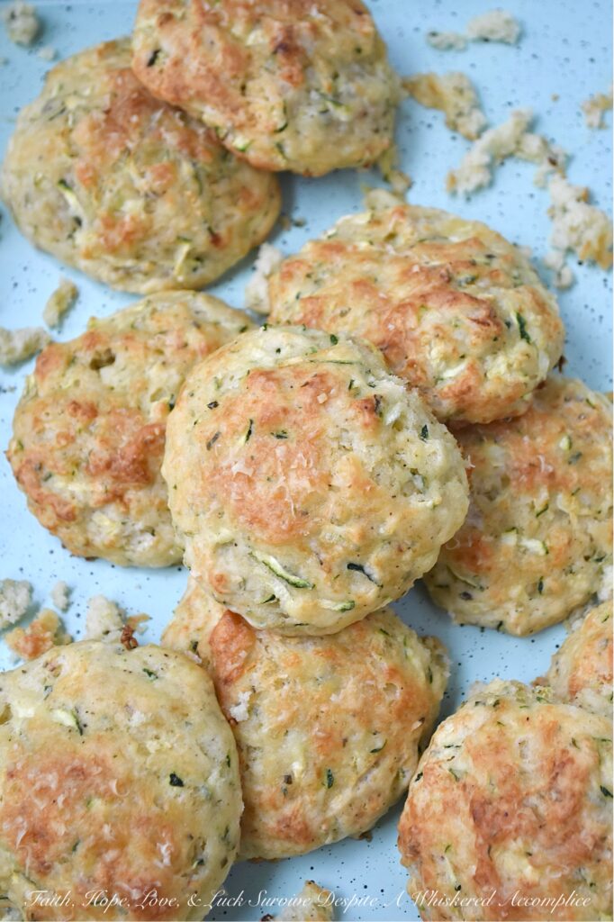 Parmesan Cheese Italian Zucchini Drop Biscuits - Packed with savory Italian seasoning and the irresistible tang of Parmesan cheese, these buttery zucchini biscuits offer a crispy, flaky texture that pairs beautifully with just about anything. You can serve them as a side to your favorite soups or salads, but honestly, they’re just as good for breakfast with a big ol’ pat of butter melting on top. If you’re looking for an easy-to-make biscuit recipe that’s got a little something extra going on, these zucchini drop biscuits are it.