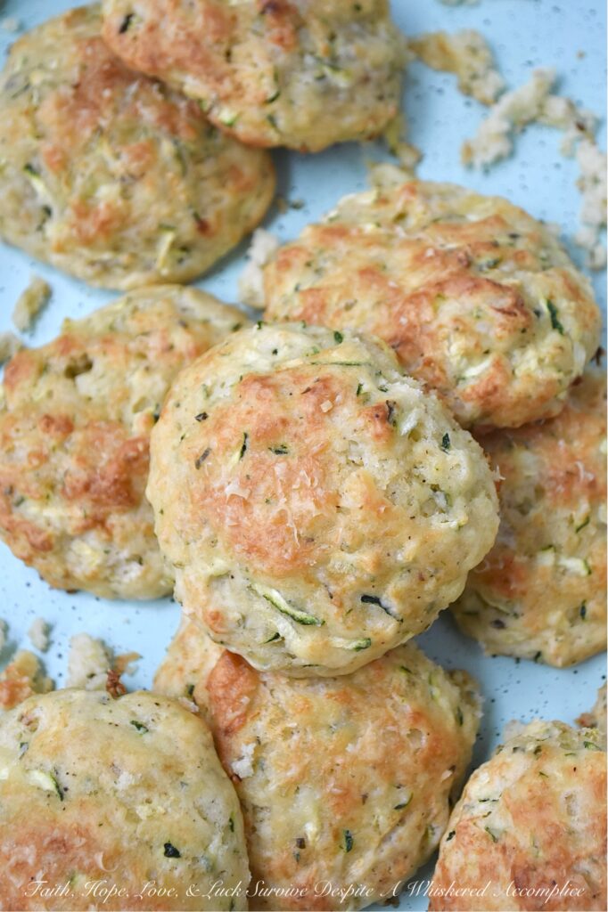 Parmesan Cheese Italian Zucchini Drop Biscuits - Packed with savory Italian seasoning and the irresistible tang of Parmesan cheese, these buttery zucchini biscuits offer a crispy, flaky texture that pairs beautifully with just about anything. You can serve them as a side to your favorite soups or salads, but honestly, they’re just as good for breakfast with a big ol’ pat of butter melting on top. If you’re looking for an easy-to-make biscuit recipe that’s got a little something extra going on, these zucchini drop biscuits are it.
