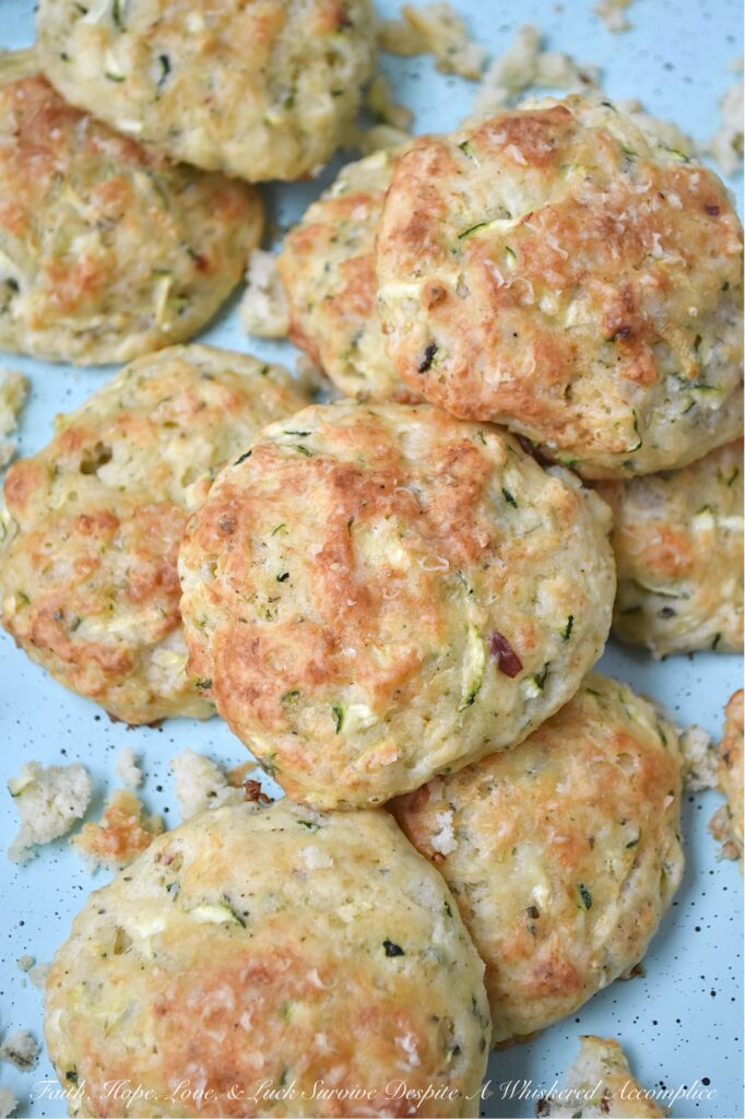Parmesan Cheese Italian Zucchini Drop Biscuits - Packed with savory Italian seasoning and the irresistible tang of Parmesan cheese, these buttery zucchini biscuits offer a crispy, flaky texture that pairs beautifully with just about anything. You can serve them as a side to your favorite soups or salads, but honestly, they’re just as good for breakfast with a big ol’ pat of butter melting on top. If you’re looking for an easy-to-make biscuit recipe that’s got a little something extra going on, these zucchini drop biscuits are it.