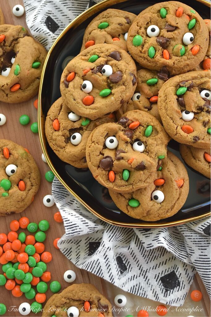 M&M's Minis Halloween Molasses Spice Cookies - These classic, irresistibly chewy molasses spice cookies are getting a delightfully spooky-cute makeover this Halloween season. They’re everything you love about fall. Rich, deeply spiced, and perfectly soft, but with a mischievous, whimsical festive holiday twist. Chocolate chips peeking out from the dough, candy eyeballs staring back at you like they’re up to no good, and a handful of Milk Chocolate M&M’s Minis for a pop of seasonal color and crunch. These cookies are ready to haunt your cookie jar in the best possible way.