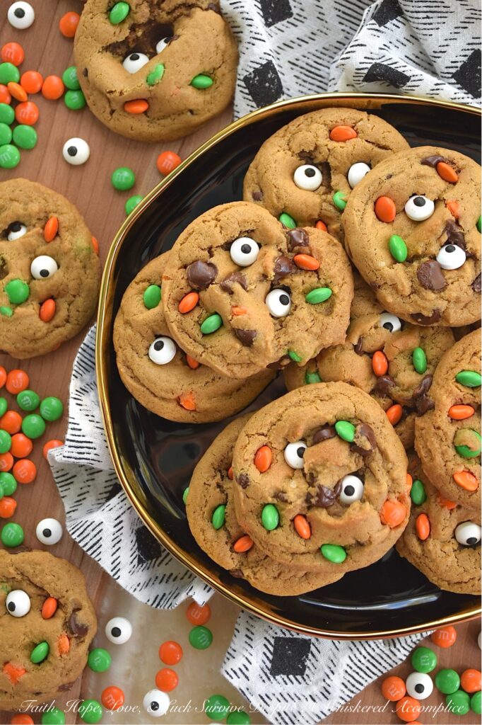 M&M's Minis Halloween Molasses Spice Cookies - These classic, irresistibly chewy molasses spice cookies are getting a delightfully spooky-cute makeover this Halloween season. They’re everything you love about fall. Rich, deeply spiced, and perfectly soft, but with a mischievous, whimsical festive holiday twist. Chocolate chips peeking out from the dough, candy eyeballs staring back at you like they’re up to no good, and a handful of Milk Chocolate M&M’s Minis for a pop of seasonal color and crunch. These cookies are ready to haunt your cookie jar in the best possible way.