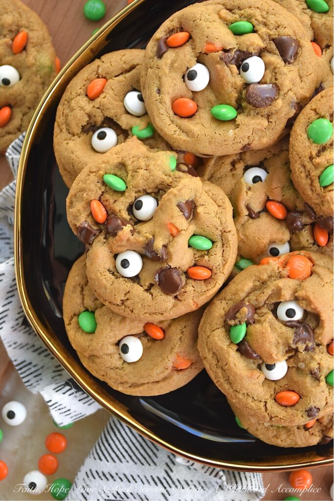 M&M's Minis Halloween Molasses Spice Cookies - These classic, irresistibly chewy molasses spice cookies are getting a delightfully spooky-cute makeover this Halloween season. They’re everything you love about fall. Rich, deeply spiced, and perfectly soft, but with a mischievous, whimsical festive holiday twist. Chocolate chips peeking out from the dough, candy eyeballs staring back at you like they’re up to no good, and a handful of Milk Chocolate M&M’s Minis for a pop of seasonal color and crunch. These cookies are ready to haunt your cookie jar in the best possible way.