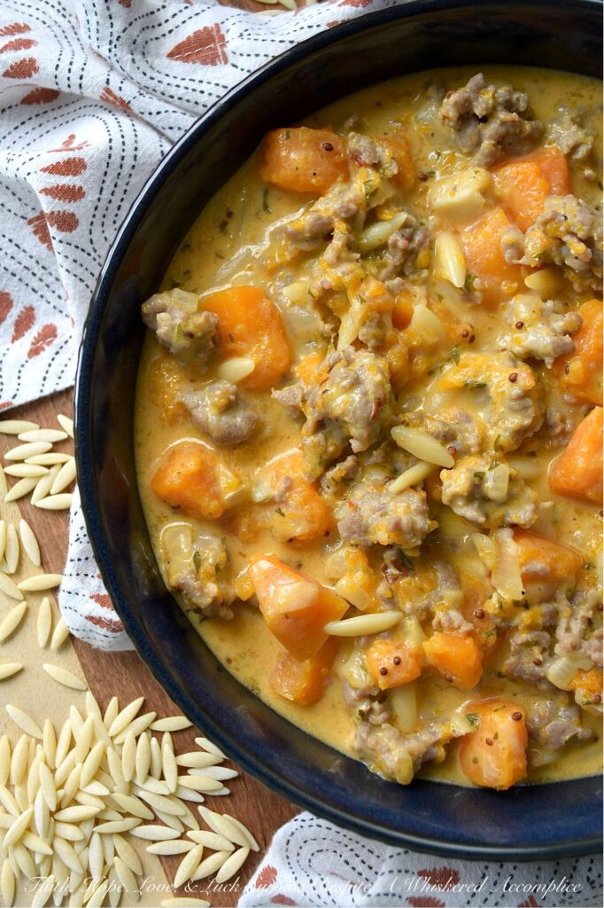 Italian Sausage & Orzo Butternut Squash Soup - There's a special kind of disappointment that comes from finishing a beautiful bowl of soup, only to find your stomach rumbling an hour later. With this flavor-packed, chunky butternut squash soup, we can almost guarantee that your stomach will be satisfied for hours. Sweet Italian sausage and just a bit of orzo pasta transform this seasonal butternut squash soup into a hearty and filling one-pot recipe that's the ultimate answer to "What's for Dinner?" on a cold fall or winter's day. Forget thin broths and simple purées; finished with a generous cup of heavy cream, this rich, flavorful, and unbelievably cozy pot of soup is one you'll come back to all season long.