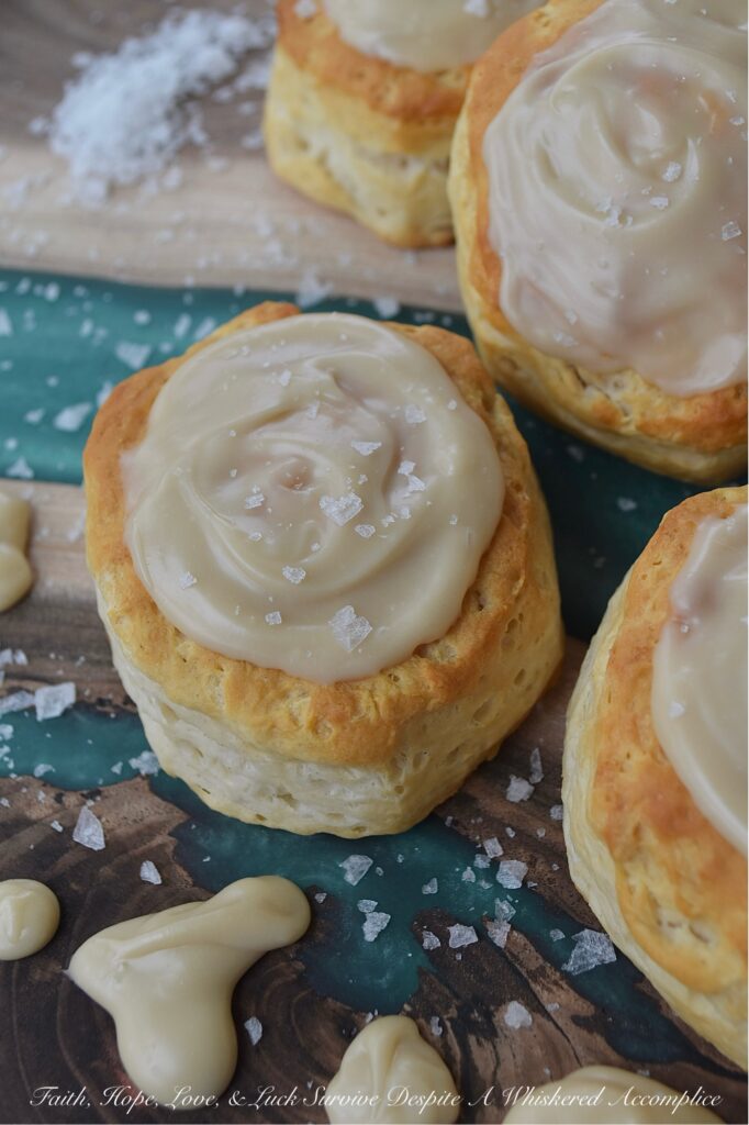 Maple & Buttered Rum Iced Whomp Biscuits - If you're someone who keeps a can or two of trusty refrigerated biscuits, tucked away in your fridge for breakfast emergencies or those nights when breakfast-for-dinner is a common solution to what's for dinner, these Maple & Buttered Rum Iced Whomp Biscuits are a must-try. Traditional whomp biscuits get a serious glow-up, with a swoon-worthy spread of dreamy maple, butter, and rum-flavored icing, followed by a sprinkle of sea salt to balance out the icing's sweet, sticky goodness. After trying these biscuits, you’ll never look at a can of whomp biscuits the same way again.