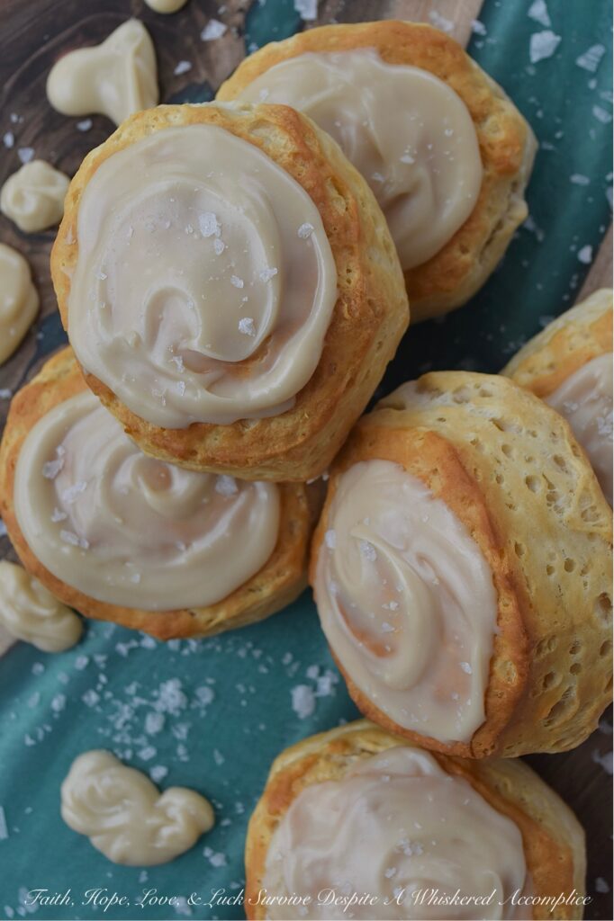 Maple & Buttered Rum Iced Whomp Biscuits - If you're someone who keeps a can or two of trusty refrigerated biscuits, tucked away in your fridge for breakfast emergencies or those nights when breakfast-for-dinner is a common solution to what's for dinner, these Maple & Buttered Rum Iced Whomp Biscuits are a must-try. Traditional whomp biscuits get a serious glow-up, with a swoon-worthy spread of dreamy maple, butter, and rum-flavored icing, followed by a sprinkle of sea salt to balance out the icing's sweet, sticky goodness. After trying these biscuits, you’ll never look at a can of whomp biscuits the same way again.