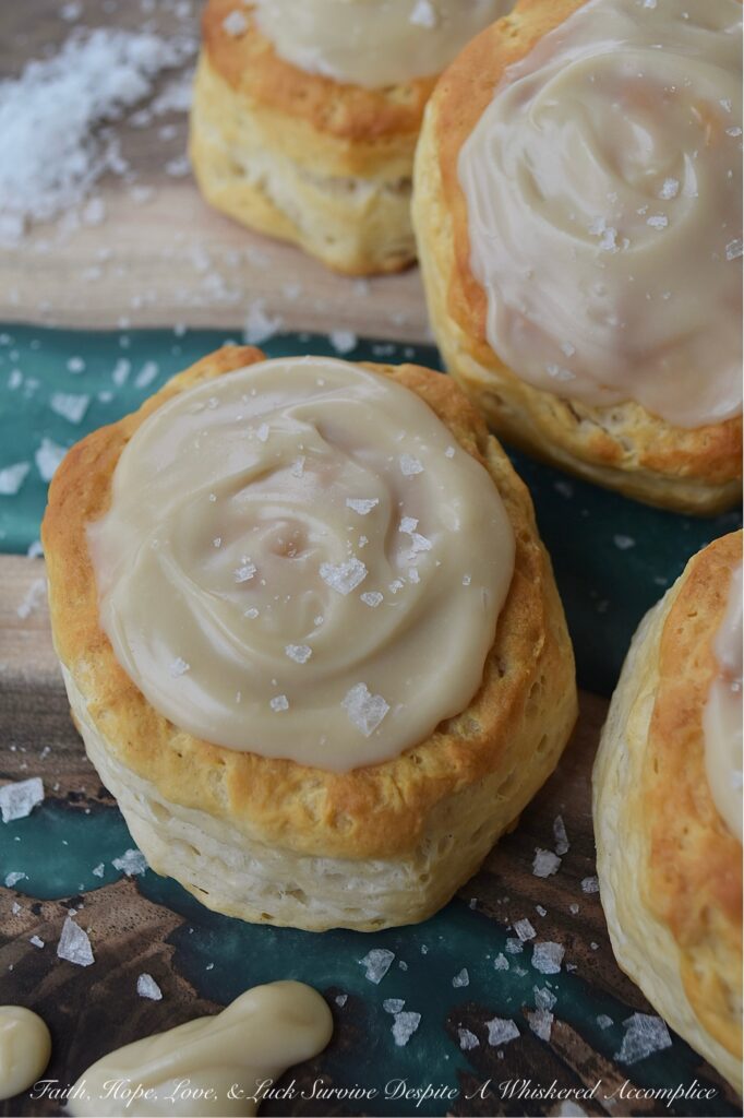 Maple & Buttered Rum Iced Whomp Biscuits - If you're someone who keeps a can or two of trusty refrigerated biscuits, tucked away in your fridge for breakfast emergencies or those nights when breakfast-for-dinner is a common solution to what's for dinner, these Maple & Buttered Rum Iced Whomp Biscuits are a must-try. Traditional whomp biscuits get a serious glow-up, with a swoon-worthy spread of dreamy maple, butter, and rum-flavored icing, followed by a sprinkle of sea salt to balance out the icing's sweet, sticky goodness. After trying these biscuits, you’ll never look at a can of whomp biscuits the same way again.