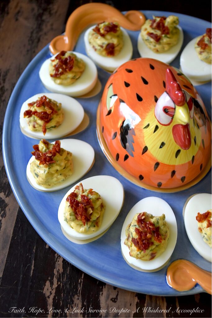 Chunky Sun-Dried Tomato & Basil Deviled Eggs - I think we can all agree that not every deviled egg is a showstopper. But these chunky sun-dried tomato and fresh basil deviled eggs? They’re the kind of appetizer that makes people pause mid-bite, look at you with wide eyes, and demand to know what magic you’ve tucked inside. With a rich, creamy yolk filling studded with chewy, intensely sweet sun-dried tomatoes and flecked with fresh, fragrant basil, these little appetizer gems are perfect for any occasion that calls for a truly standout bite. One thing is for sure, no matter when you serve them, these Italian-style deviled eggs are guaranteed to disappear quickly.