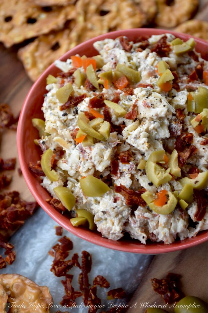 Italian Mozzarella & Green Olive Cheese Spread - If you’re looking for a cheese spread that’s ready to party, this Italian-inspired mozzarella cheese spread is it. Loaded with salty pimento-stuffed green olives, sweet sun-dried tomatoes, and a good sprinkle of Italian herbs, this is the kind of cheesy goodness that’s just as happy piled onto pretzels, crackers, or pita crisps as it is tucked inside a mini sandwich. And, with its cheery pop of red and green, this appetizer is basically waving its arms and shouting, "Pick me!" for your holiday snack table.