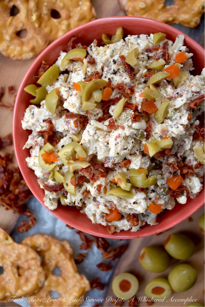 Italian Mozzarella & Green Olive Cheese Spread - If you’re looking for a cheese spread that’s ready to party, this Italian-inspired mozzarella cheese spread is it. Loaded with salty pimento-stuffed green olives, sweet sun-dried tomatoes, and a good sprinkle of Italian herbs, this is the kind of cheesy goodness that’s just as happy piled onto pretzels, crackers, or pita crisps as it is tucked inside a mini sandwich. And, with its cheery pop of red and green, this appetizer is basically waving its arms and shouting, "Pick me!" for your holiday snack table.