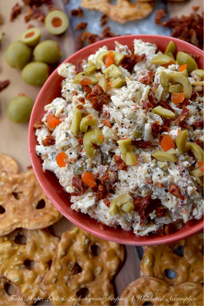 Italian Mozzarella & Green Olive Cheese Spread - If you’re looking for a cheese spread that’s ready to party, this Italian-inspired mozzarella cheese spread is it. Loaded with salty pimento-stuffed green olives, sweet sun-dried tomatoes, and a good sprinkle of Italian herbs, this is the kind of cheesy goodness that’s just as happy piled onto pretzels, crackers, or pita crisps as it is tucked inside a mini sandwich. And, with its cheery pop of red and green, this appetizer is basically waving its arms and shouting, "Pick me!" for your holiday snack table.