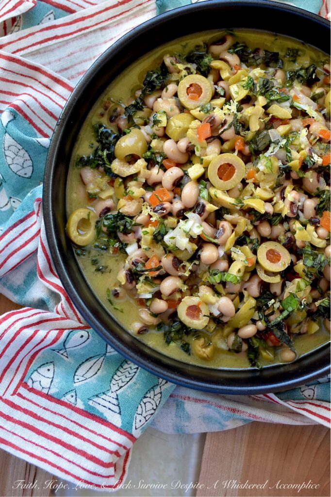 Black-Eyed Pea & Basil Green Olive Salad - Let's be honest. Black-eyed peas by themselves are pretty plain and don’t have much flavor, despite their reputation for bringing good luck. But when you mix them with chopped pimento-stuffed green olives, plenty of fresh basil, and a tangy lemon, mustard, and honey dressing, they become something truly special. This black-eyed pea salad is just begging to be the star at your next party, gathering, or New Year’s Day celebration. Whether you pile it high on triangle-sliced pita, scoop it up with crunchy tortilla chips, or simply eat it straight from the bowl as a side dish, this green olive salad is sure to be a hit.