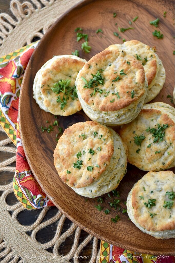 Savory Fresh Parsley Layered Biscuits - Y’all, I’m not saying you need to eat these savory layered biscuits straight from the oven, but I highly recommend it. With their layers upon layers of buttery, flaky goodness and their savory burst of garlic powder, onion powder, and fresh parsley, these biscuits are about to become your absolute fave. And, if you’re feeling a wee bit indulgent, why not go ahead and drizzle a bit of honey over the top of them for a sweet and savory treat? Whether served with bacon and eggs, alongside a warm bowl of soup, or simply spread with a bit of fruity jam or preserves, these biscuits are about to become your newest obsession. Don't say I didn't warn you.