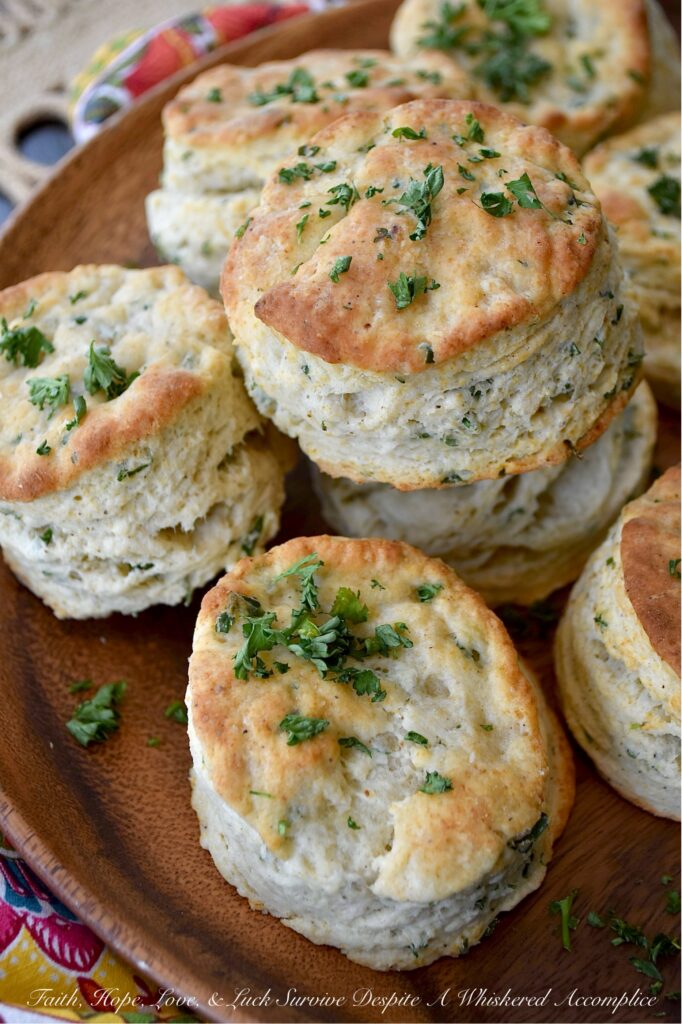 Savory Fresh Parsley Layered Biscuits - Y’all, I’m not saying you need to eat these savory layered biscuits straight from the oven, but I highly recommend it. With their layers upon layers of buttery, flaky goodness and their savory burst of garlic powder, onion powder, and fresh parsley, these biscuits are about to become your absolute fave. And, if you’re feeling a wee bit indulgent, why not go ahead and drizzle a bit of honey over the top of them for a sweet and savory treat? Whether served with bacon and eggs, alongside a warm bowl of soup, or simply spread with a bit of fruity jam or preserves, these biscuits are about to become your newest obsession. Don't say I didn't warn you.