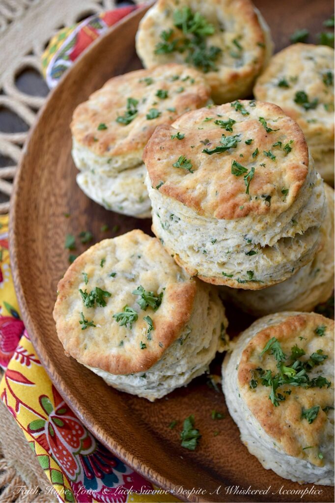 Savory Fresh Parsley Layered Biscuits - Y’all, I’m not saying you need to eat these savory layered biscuits straight from the oven, but I highly recommend it. With their layers upon layers of buttery, flaky goodness and their savory burst of garlic powder, onion powder, and fresh parsley, these biscuits are about to become your absolute fave. And, if you’re feeling a wee bit indulgent, why not go ahead and drizzle a bit of honey over the top of them for a sweet and savory treat? Whether served with bacon and eggs, alongside a warm bowl of soup, or simply spread with a bit of fruity jam or preserves, these biscuits are about to become your newest obsession. Don't say I didn't warn you.