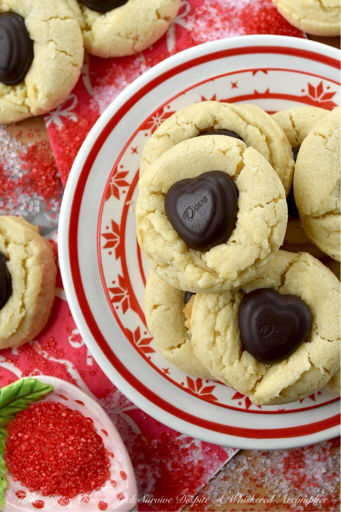 Heart-Melting Simple Vanilla Sugar Cookies - These simple Valentine's Day sugar cookies, decorated with heart-shaped chocolates, are flaky, golden, and delicately crumbly. Buttery, vanilla-flavored, and balanced with a wee hint of salt to make every flavor pop, they're the perfect sweet treat to surprise a loved one or to treat yourself. They're sure to melt your heart with every sweet, sugary, chocolatey bite.