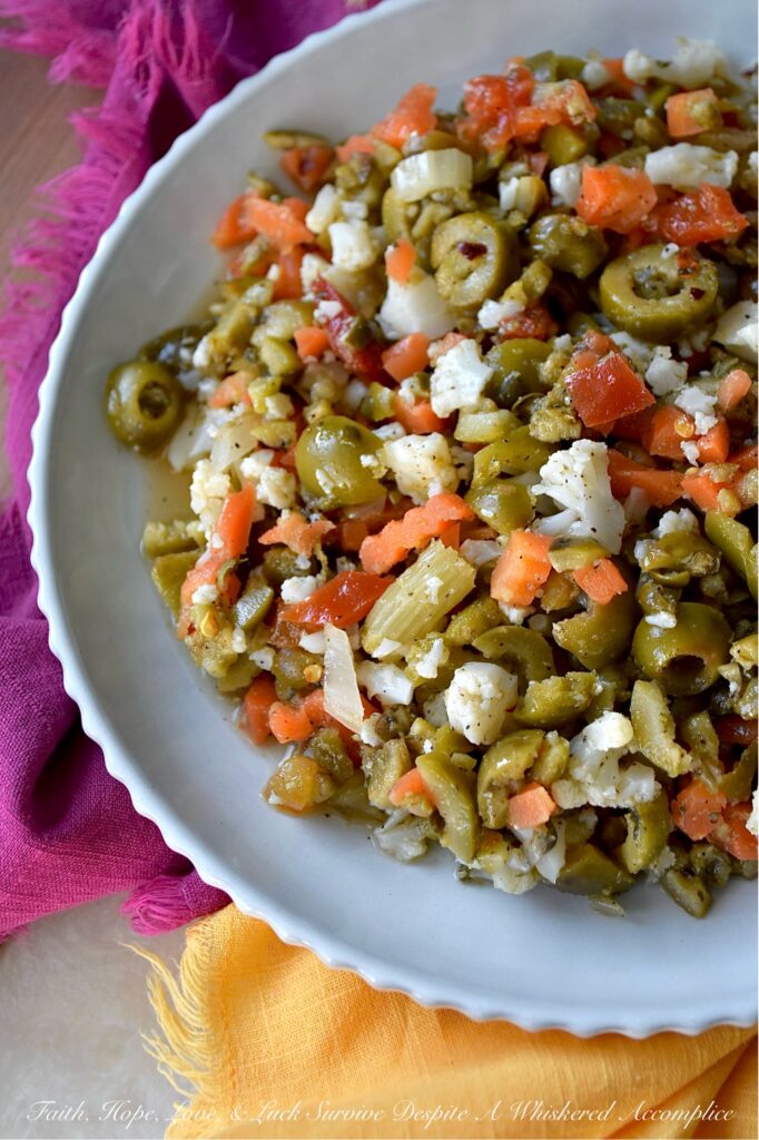 Mild Green Olive Salad Muffuletta Spread - Of course, this green olive salad is the classic go-to for muffuletta sandwiches, but it’s just as irresistible piled onto a hot, cheesy pizza, creamy deviled eggs, or simply scooped up or spread on a hunk of crusty bread. With buttery-soft green, ripe, pitted olives, mild giardiniera, and capers all mingling together in a simple red wine vinaigrette, you get a burst of flavor that’s big on taste but not on heat. Basically, this is the kind of condiment you’ll want to slather on just about every sandwich you make from here on out.
