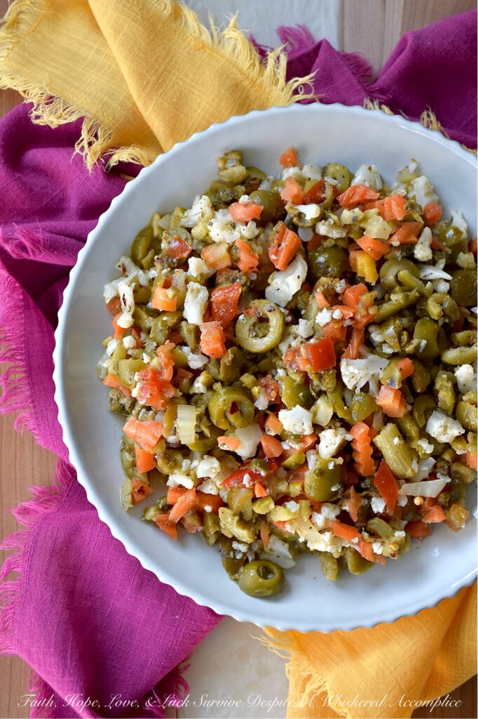 Mild Green Olive Salad Muffuletta Spread - Of course, this green olive salad is the classic go-to for muffuletta sandwiches, but it’s just as irresistible piled onto a hot, cheesy pizza, creamy deviled eggs, or simply scooped up or spread on a hunk of crusty bread. With buttery-soft green, ripe, pitted olives, mild giardiniera, and capers all mingling together in a simple red wine vinaigrette, you get a burst of flavor that’s big on taste but not on heat. Basically, this is the kind of condiment you’ll want to slather on just about every sandwich you make from here on out.