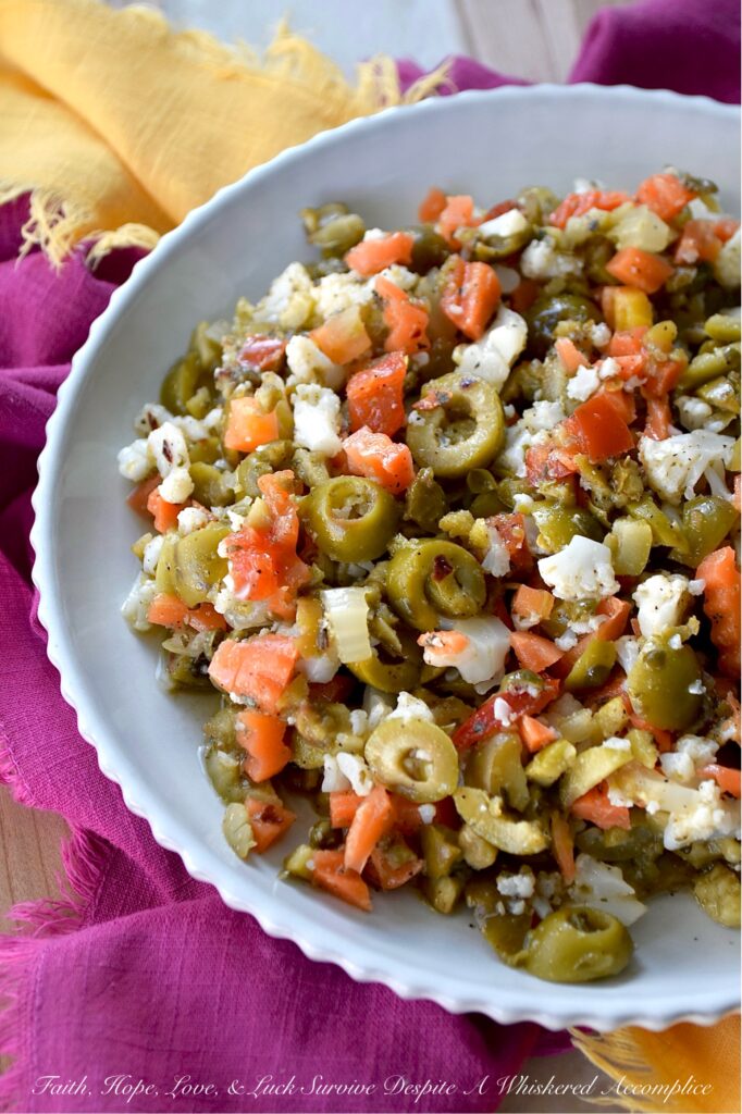 Mild Green Olive Salad Muffuletta Spread - Of course, this green olive salad is the classic go-to for muffuletta sandwiches, but it’s just as irresistible piled onto a hot, cheesy pizza, creamy deviled eggs, or simply scooped up or spread on a hunk of crusty bread. With buttery-soft green, ripe, pitted olives, mild giardiniera, and capers all mingling together in a simple red wine vinaigrette, you get a burst of flavor that’s big on taste but not on heat. Basically, this is the kind of condiment you’ll want to slather on just about every sandwich you make from here on out.