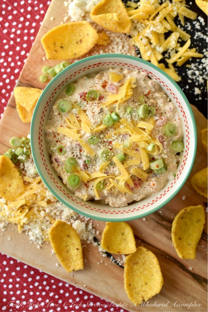 Parmesan & Cheddar Pimento Corn Chip Dip - If you're a wimp when it comes to spicy food, this flavorful Parmesan and Cheddar corn chip dip is for you. It's creamy, cheesy, absolutely packed with diced pimento, and full of flavor, without the heat found in most traditional corn chip dips. Paired with crunchy corn chips, it's the ultimate party starter, game day snack, or stay-at-home movie-night treat. And, if you’re the type of person who likes to live dangerously and crank up the heat, go right on ahead and fold in a finely chopped jalapeño. Don't be afraid to play around with the ingredients in this recipe and make it your own.