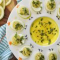 Whipped Feta Lemon Zest & Basil Deviled Eggs - These sophisticated deviled eggs are filled with a creamy whipped feta dip made with salty feta, smooth cream cheese, lemon zest, fresh basil, and a hint of honey. With a touch of whole grain mustard, crushed red pepper flakes, and even more fresh basil for added flavor, these deviled eggs are bright, creamy, and perfect for when you need an elegant appetizer to steal the show. A final drizzle of honey and a sprinkle of fresh basil really help make them as gorgeous as they are delicious. And since you'll only use 3/4 cup of the whipped feta for this recipe, you'll have plenty left over to enjoy as a snack with pita bread, pretzels, or pita crackers.