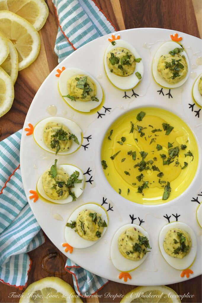 Whipped Feta Lemon Zest & Basil Deviled Eggs - These sophisticated deviled eggs are filled with a creamy whipped feta dip made with salty feta, smooth cream cheese, lemon zest, fresh basil, and a hint of honey. With a touch of whole grain mustard, crushed red pepper flakes, and even more fresh basil for added flavor, these deviled eggs are bright, creamy, and perfect for when you need an elegant appetizer to steal the show. A final drizzle of honey and a sprinkle of fresh basil really help make them as gorgeous as they are delicious. And since you'll only use 3/4 cup of the whipped feta for this recipe, you'll have plenty left over to enjoy as a snack with pita bread, pretzels, or pita crackers.
