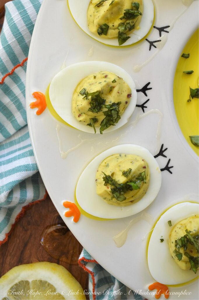 Whipped Feta Lemon Zest & Basil Deviled Eggs - These sophisticated deviled eggs are filled with a creamy whipped feta dip made with salty feta, smooth cream cheese, lemon zest, fresh basil, and a hint of honey. With a touch of whole grain mustard, crushed red pepper flakes, and even more fresh basil for added flavor, these deviled eggs are bright, creamy, and perfect for when you need an elegant appetizer to steal the show. A final drizzle of honey and a sprinkle of fresh basil really help make them as gorgeous as they are delicious. And since you'll only use 3/4 cup of the whipped feta for this recipe, you'll have plenty left over to enjoy as a snack with pita bread, pretzels, or pita crackers.