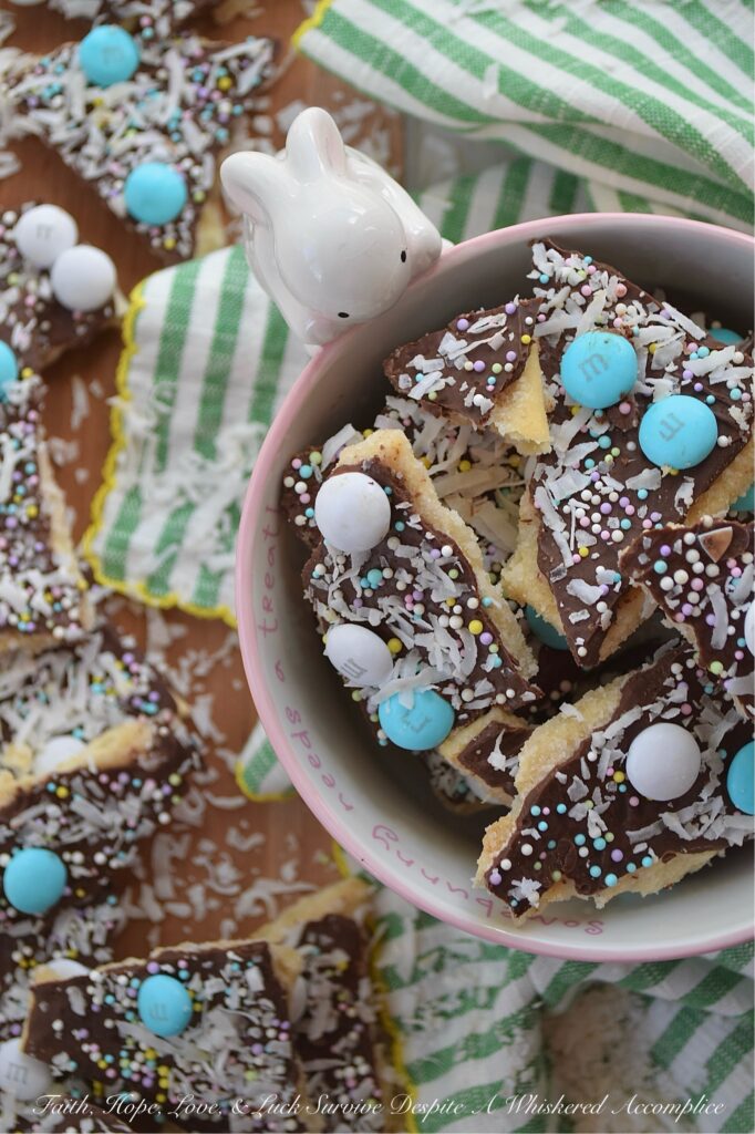Cracker Candy with M&M's & Shredded Coconut - If you’re ready to take the classic salty-sweet crunch of traditional cracker candy to a whole new level, you’ve come to the right place. This bumped-up version of cracker candy combines the crispness of saltine crackers with a rich, buttery toffee, a smooth layer of melted chocolate, a colorful shower of sprinkles, decorative Milk Chocolate M&M's, and crunchy unsweetened shredded coconut. And, the best part is, you can swap out the sprinkles and M&M’s for any color combo your lil' heart desires, which means this treat is ready to easily dress up for any holiday, birthday, or random Wednesday that needs a little extra sweetness.