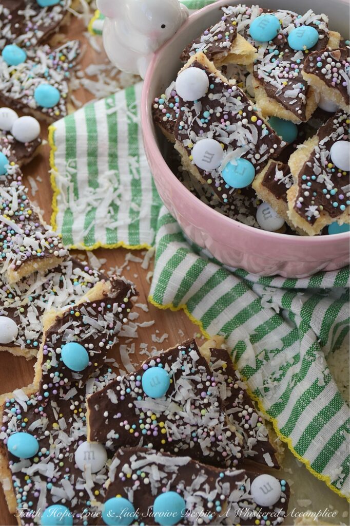 Cracker Candy with M&M's & Shredded Coconut - If you’re ready to take the classic salty-sweet crunch of traditional cracker candy to a whole new level, you’ve come to the right place. This bumped-up version of cracker candy combines the crispness of saltine crackers with a rich, buttery toffee, a smooth layer of melted chocolate, a colorful shower of sprinkles, decorative Milk Chocolate M&M's, and crunchy unsweetened shredded coconut. And, the best part is, you can swap out the sprinkles and M&M’s for any color combo your lil' heart desires, which means this treat is ready to easily dress up for any holiday, birthday, or random Wednesday that needs a little extra sweetness.