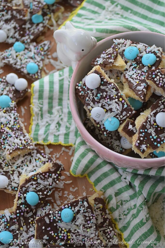 Cracker Candy with M&M's & Shredded Coconut - If you’re ready to take the classic salty-sweet crunch of traditional cracker candy to a whole new level, you’ve come to the right place. This bumped-up version of cracker candy combines the crispness of saltine crackers with a rich, buttery toffee, a smooth layer of melted chocolate, a colorful shower of sprinkles, decorative Milk Chocolate M&M's, and crunchy unsweetened shredded coconut. And, the best part is, you can swap out the sprinkles and M&M’s for any color combo your lil' heart desires, which means this treat is ready to easily dress up for any holiday, birthday, or random Wednesday that needs a little extra sweetness.