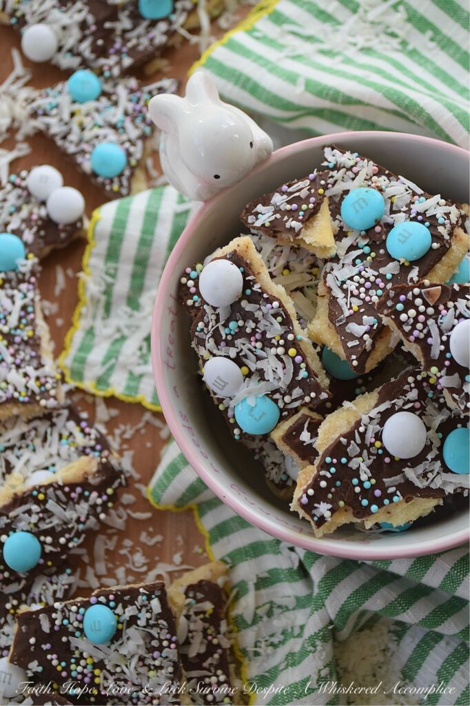 Cracker Candy with M&M's & Shredded Coconut - If you’re ready to take the classic salty-sweet crunch of traditional cracker candy to a whole new level, you’ve come to the right place. This bumped-up version of cracker candy combines the crispness of saltine crackers with a rich, buttery toffee, a smooth layer of melted chocolate, a colorful shower of sprinkles, decorative Milk Chocolate M&M's, and crunchy unsweetened shredded coconut. And, the best part is, you can swap out the sprinkles and M&M’s for any color combo your lil' heart desires, which means this treat is ready to easily dress up for any holiday, birthday, or random Wednesday that needs a little extra sweetness.