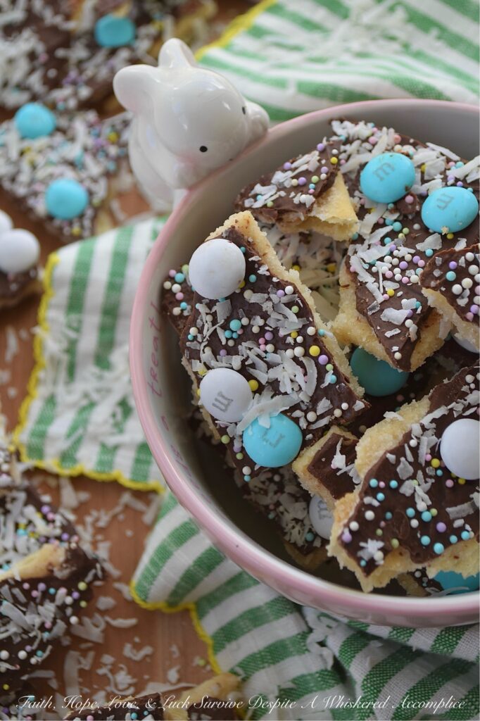 Cracker Candy with M&M's & Shredded Coconut - If you’re ready to take the classic salty-sweet crunch of traditional cracker candy to a whole new level, you’ve come to the right place. This bumped-up version of cracker candy combines the crispness of saltine crackers with a rich, buttery toffee, a smooth layer of melted chocolate, a colorful shower of sprinkles, decorative Milk Chocolate M&M's, and crunchy unsweetened shredded coconut. And, the best part is, you can swap out the sprinkles and M&M’s for any color combo your lil' heart desires, which means this treat is ready to easily dress up for any holiday, birthday, or random Wednesday that needs a little extra sweetness.