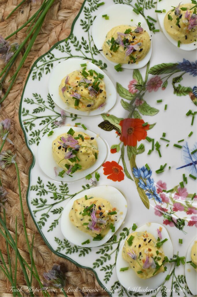 Everything Bagel Chive Blossom Deviled Eggs - From May to June, chive blossoms make their annual appearance, and if you aren't eating the flowers, you're missing out on the best secret in your late spring to early summer garden. These edible flowers offer a subtle, sweet, sophisticated onion flavor that pairs perfectly with the rich, creamy filling of a deviled egg. With everything bagel seasoning, finely chopped fresh chives, and chive florets, this recipe hits that perfect balance of crunch, creaminess, and garden-fresh flavor. Fresh, sophisticated, and undeniably gorgeous, these deviled eggs are a must-make while the chive blossom blooms are still in their prime.