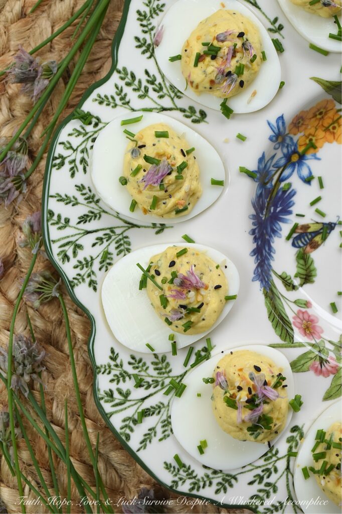 Everything Bagel Chive Blossom Deviled Eggs - From May to June, chive blossoms make their annual appearance, and if you aren't eating the flowers, you're missing out on the best secret in your late spring to early summer garden. These edible flowers offer a subtle, sweet, sophisticated onion flavor that pairs perfectly with the rich, creamy filling of a deviled egg. With everything bagel seasoning, finely chopped fresh chives, and chive florets, this recipe hits that perfect balance of crunch, creaminess, and garden-fresh flavor. Fresh, sophisticated, and undeniably gorgeous, these deviled eggs are a must-make while the chive blossom blooms are still in their prime.