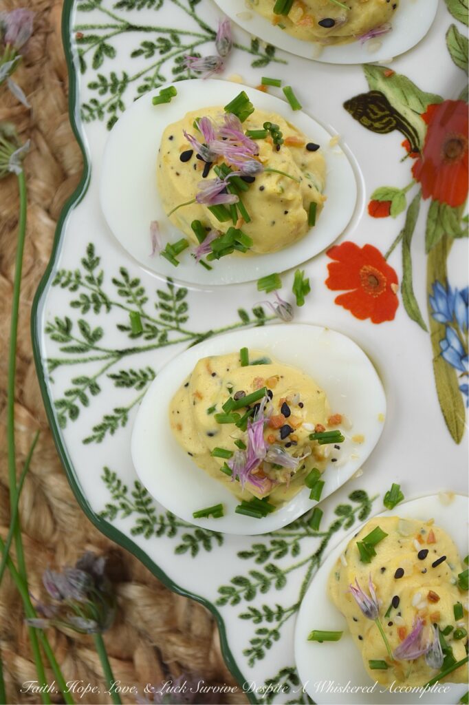 Everything Bagel Chive Blossom Deviled Eggs - From May to June, chive blossoms make their annual appearance, and if you aren't eating the flowers, you're missing out on the best secret in your late spring to early summer garden. These edible flowers offer a subtle, sweet, sophisticated onion flavor that pairs perfectly with the rich, creamy filling of a deviled egg. With everything bagel seasoning, finely chopped fresh chives, and chive florets, this recipe hits that perfect balance of crunch, creaminess, and garden-fresh flavor. Fresh, sophisticated, and undeniably gorgeous, these deviled eggs are a must-make while the chive blossom blooms are still in their prime.