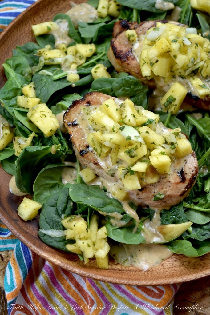 Caribbean Pineapple & Honey Mustard Pork Chops - While most of us aren’t lucky enough to be lounging on a beach in the Caribbean, we can certainly bring the spirit of the islands straight to our dinner table with these sweet and spicy grilled pork chops. The secret is an easy-to-make homemade jerk seasoning blend used to season both sides of each pork chop before grilling. That same seasoning mix is also used to make a simple honey mustard sauce and a quick pineapple sweet yellow onion salsa, both of which top each seared pork chop. Served over a crisp bed of baby spinach, this is the ultimate summer meal. Light, refreshing, and guaranteed to make your summer dinner feel like a getaway.