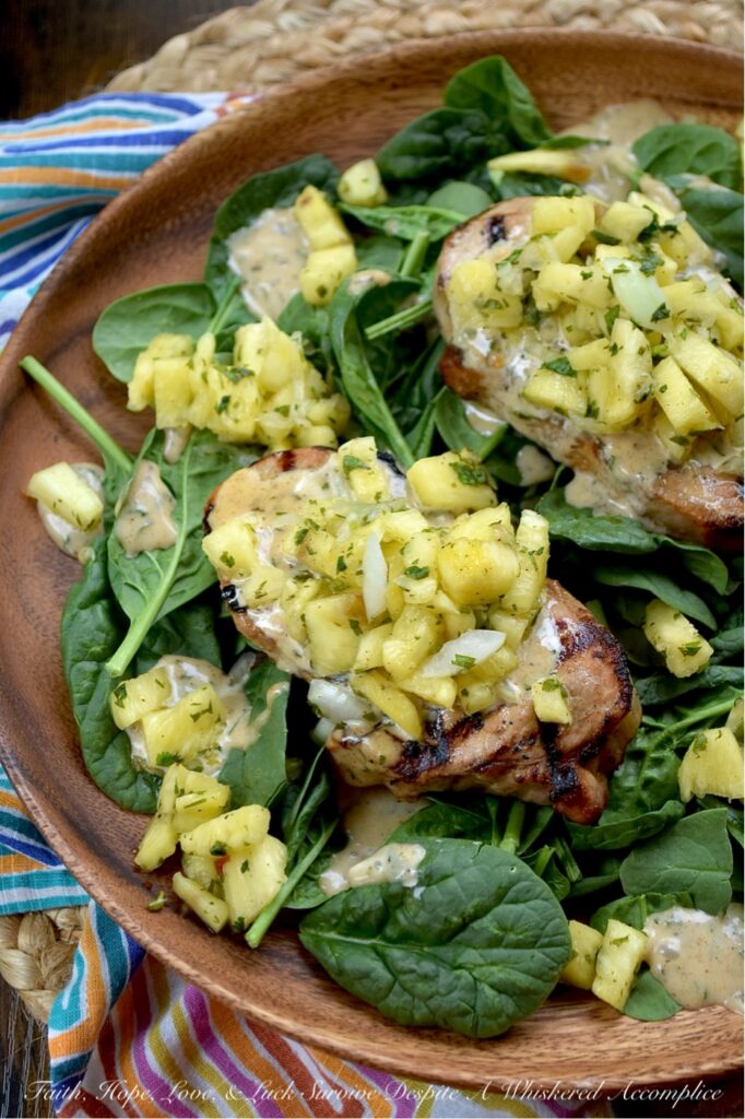 Caribbean Pineapple & Honey Mustard Pork Chops - While most of us aren’t lucky enough to be lounging on a beach in the Caribbean, we can certainly bring the spirit of the islands straight to our dinner table with these sweet and spicy grilled pork chops. The secret is an easy-to-make homemade jerk seasoning blend used to season both sides of each pork chop before grilling. That same seasoning mix is also used to make a simple honey mustard sauce and a quick pineapple sweet yellow onion salsa, both of which top each seared pork chop. Served over a crisp bed of baby spinach, this is the ultimate summer meal. Light, refreshing, and guaranteed to make your summer dinner feel like a getaway.