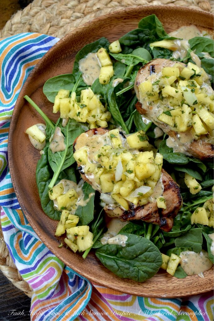 Caribbean Pineapple & Honey Mustard Pork Chops - While most of us aren’t lucky enough to be lounging on a beach in the Caribbean, we can certainly bring the spirit of the islands straight to our dinner table with these sweet and spicy grilled pork chops. The secret is an easy-to-make homemade jerk seasoning blend used to season both sides of each pork chop before grilling. That same seasoning mix is also used to make a simple honey mustard sauce and a quick pineapple sweet yellow onion salsa, both of which top each seared pork chop. Served over a crisp bed of baby spinach, this is the ultimate summer meal. Light, refreshing, and guaranteed to make your summer dinner feel like a getaway.