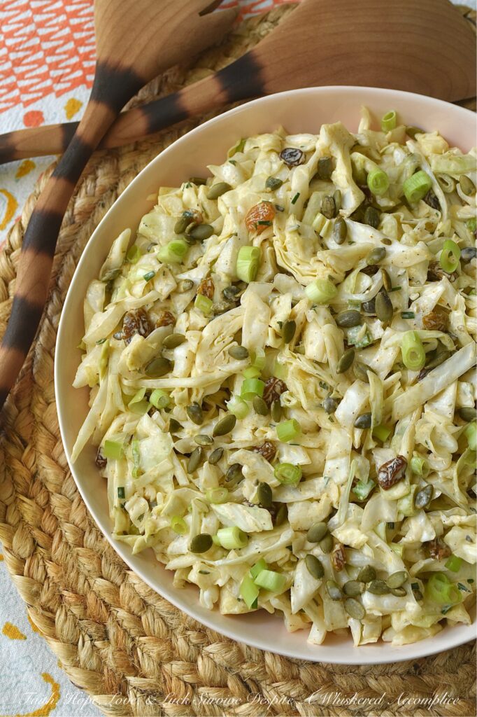 Coleslaw with Lemon Caper Remoulade - This green cabbage coleslaw is everything a summer salad should be. Crisp, refreshing, and unapologetically bold. Featuring a citrusy remoulade sauce with just enough heat to keep things interesting, this slaw hits every note. With the perfect balance of briney capers, sweet golden raisins, and roasted, salted pepitas, this isn't just a side dish; it's the star of the table.