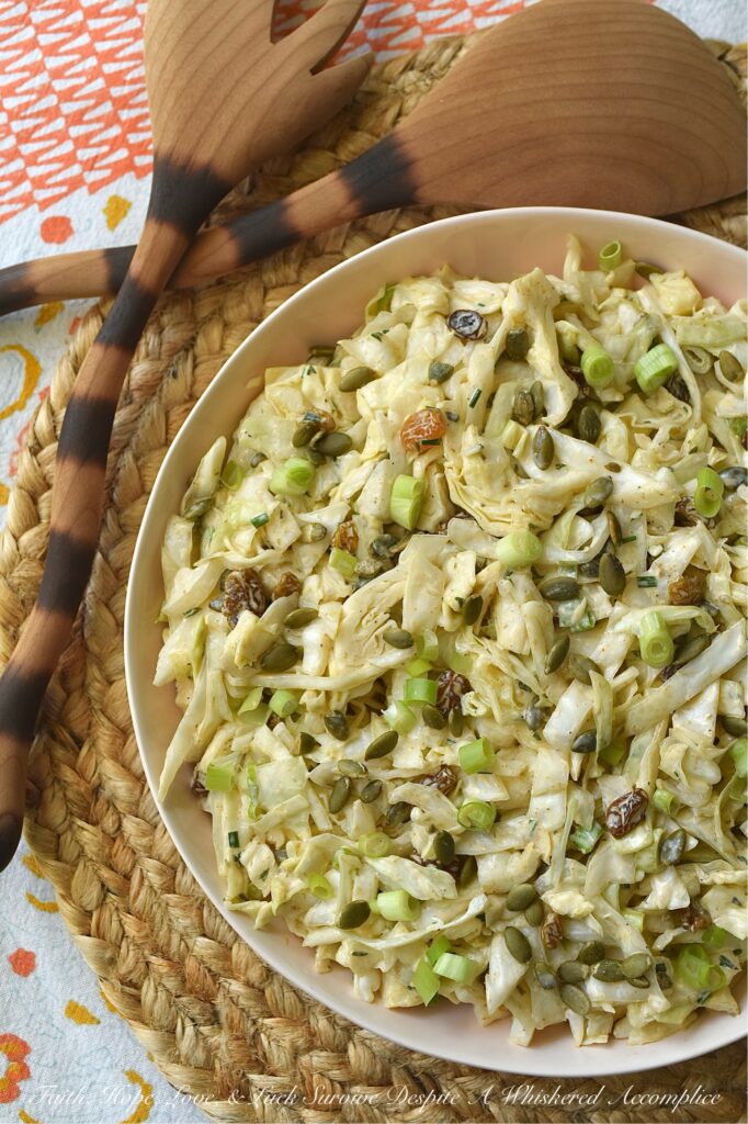Coleslaw with Lemon Caper Remoulade - This green cabbage coleslaw is everything a summer salad should be. Crisp, refreshing, and unapologetically bold. Featuring a citrusy remoulade sauce with just enough heat to keep things interesting, this slaw hits every note. With the perfect balance of briney capers, sweet golden raisins, and roasted, salted pepitas, this isn't just a side dish; it's the star of the table.