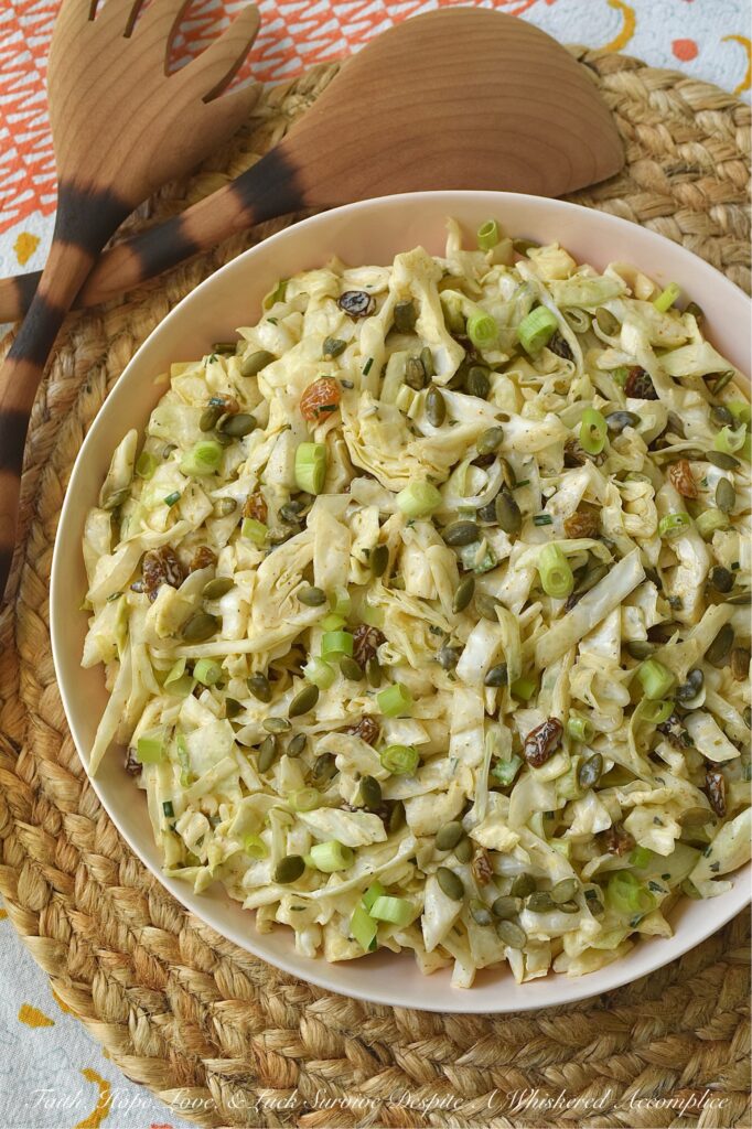 Coleslaw with Lemon Caper Remoulade - This green cabbage coleslaw is everything a summer salad should be. Crisp, refreshing, and unapologetically bold. Featuring a citrusy remoulade sauce with just enough heat to keep things interesting, this slaw hits every note. With the perfect balance of briney capers, sweet golden raisins, and roasted, salted pepitas, this isn't just a side dish; it's the star of the table.