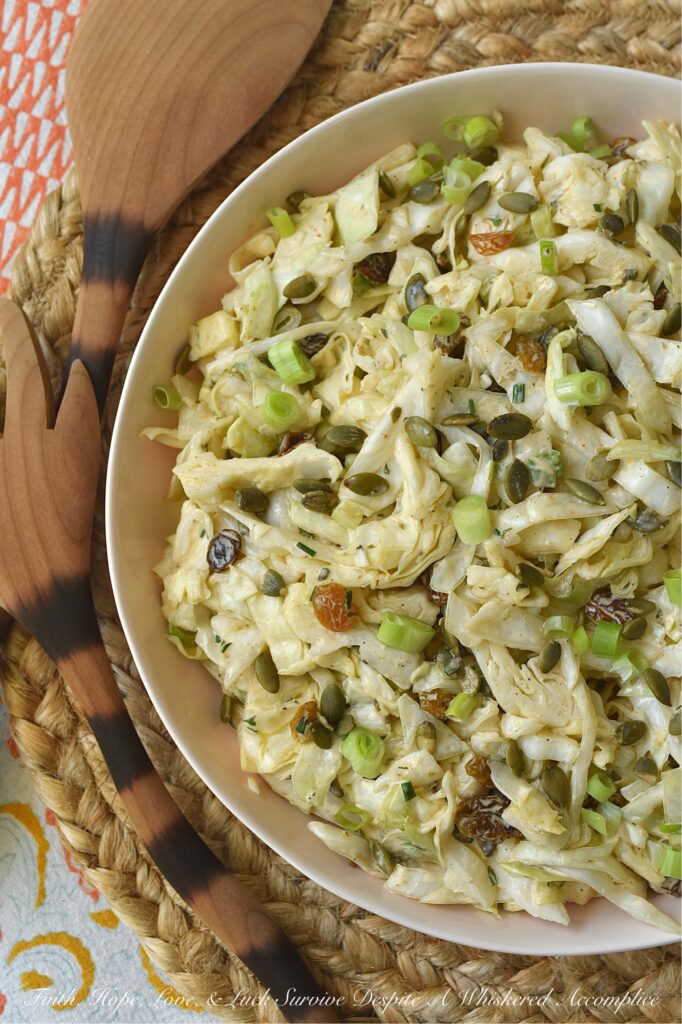 Coleslaw with Lemon Caper Remoulade - This green cabbage coleslaw is everything a summer salad should be. Crisp, refreshing, and unapologetically bold. Featuring a citrusy remoulade sauce with just enough heat to keep things interesting, this slaw hits every note. With the perfect balance of briney capers, sweet golden raisins, and roasted, salted pepitas, this isn't just a side dish; it's the star of the table.