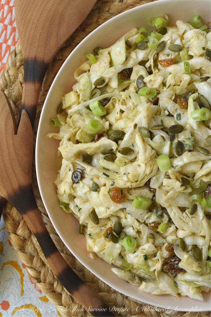 Coleslaw with Lemon Caper Remoulade - This green cabbage coleslaw is everything a summer salad should be. Crisp, refreshing, and unapologetically bold. Featuring a citrusy remoulade sauce with just enough heat to keep things interesting, this slaw hits every note. With the perfect balance of briney capers, sweet golden raisins, and roasted, salted pepitas, this isn't just a side dish; it's the star of the table.