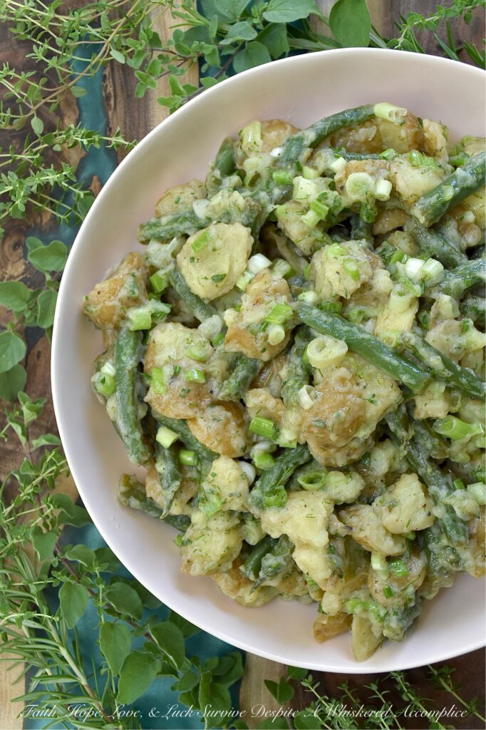 French Green Bean Potato Salad with Fresh Herbs - Featuring buttery-soft baby or little yellow potatoes, the satisfying crunch of fresh green beans, a tangy white wine vinaigrette, and a generous handful of dill, chives, oregano, thyme, and rosemary, this French Green Bean Potato Salad with Fresh Herbs is the perfect summer side dish. Mayonnaise-free, heat-friendly, and bursting with tons of fresh herb flavor, it’s everything a warm-weather side dish should be. Best of all? It can be served chilled or at room temperature. Either way is absolutely delicious.