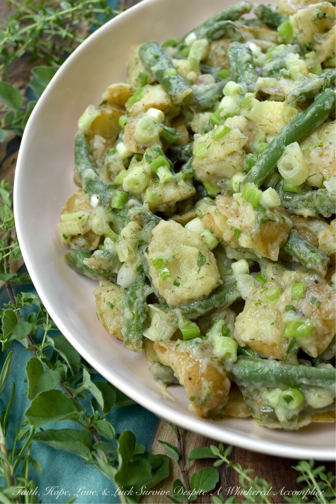 French Green Bean Potato Salad with Fresh Herbs - Featuring buttery-soft baby or little yellow potatoes, the satisfying crunch of fresh green beans, a tangy white wine vinaigrette, and a generous handful of dill, chives, oregano, thyme, and rosemary, this French Green Bean Potato Salad with Fresh Herbs is the perfect summer side dish. Mayonnaise-free, heat-friendly, and bursting with tons of fresh herb flavor, it’s everything a warm-weather side dish should be. Best of all? It can be served chilled or at room temperature. Either way is absolutely delicious.