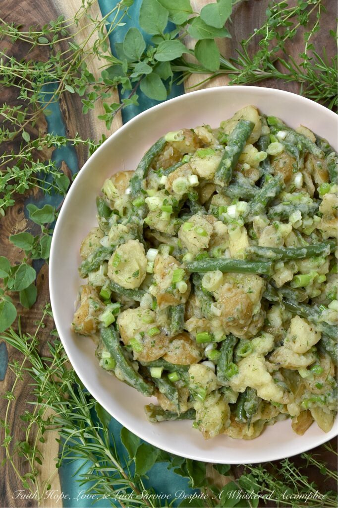 French Green Bean Potato Salad with Fresh Herbs - Featuring buttery-soft baby or little yellow potatoes, the satisfying crunch of fresh green beans, a tangy white wine vinaigrette, and a generous handful of dill, chives, oregano, thyme, and rosemary, this French Green Bean Potato Salad with Fresh Herbs is the perfect summer side dish. Mayonnaise-free, heat-friendly, and bursting with tons of fresh herb flavor, it’s everything a warm-weather side dish should be. Best of all? It can be served chilled or at room temperature. Either way is absolutely delicious.