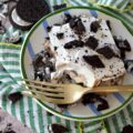 Mom's Famous Ice Cream Mississippi Mud Pie - You know that one famous dessert that Mom always made, the one everyone waited practically all year for? For my family, it was this Mississippi Mud Pie. A layered frozen dessert masterpiece of crushed chocolate sandwich cookies, creamy vanilla ice cream, decadent hot fudge topping, and a crowning layer of fluffy, cloud-like whipped topping. Whether you use a carton or two of store-bought ice cream or churn your own for this recipe, one bite will tell you exactly why this became the legendary treat of our childhood household.