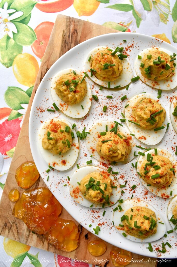Jerk Seasoned Caribbean Marmalade Deviled Eggs - These jerk-seasoned deviled eggs pack a serious island punch, blending the smoky heat of homemade jerk seasoning with the unexpected, bright, and bitter sweetness of orange marmalade. They’re creamy, deeply spiced, and just plain ol' gorgeous on a deviled egg platter. Topped with a vibrant pop of fresh chives and a dusting of paprika, these Caribbean beauties bring a taste of the islands directly to your kitchen table with no plane ticket required.
