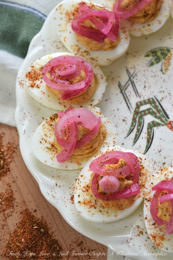 Pickled Red Onion Southwestern Deviled Eggs - These Southwest-inspired deviled eggs are ultra-creamy, perfectly tangy, and loaded with a savory, custom-blended Smoky Southwestern Seasoning that doesn't rely on heat to deliver massive flavor. Finished with a sprinkle of extra seasoning and vibrant, ridiculously easy-to-make lime juice-pickled red onions for the ultimate zesty crunch, this unforgettable deviled egg recipe is guaranteed to be a hit at your next backyard barbecue, game day, or family gathering.