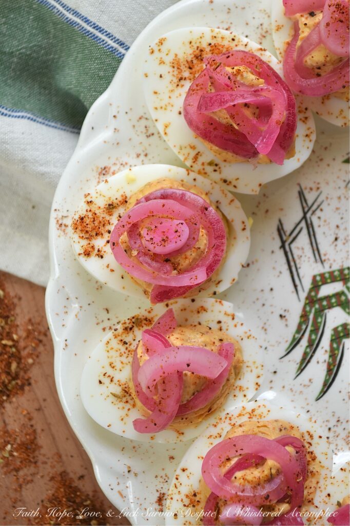Pickled Red Onion Southwestern Deviled Eggs - These Southwest-inspired deviled eggs are ultra-creamy, perfectly tangy, and loaded with a savory, custom-blended Smoky Southwestern Seasoning that doesn't rely on heat to deliver massive flavor. Finished with a sprinkle of extra seasoning and vibrant, ridiculously easy-to-make lime juice-pickled red onions for the ultimate zesty crunch, this unforgettable deviled egg recipe is guaranteed to be a hit at your next backyard barbecue, game day, or family gathering.